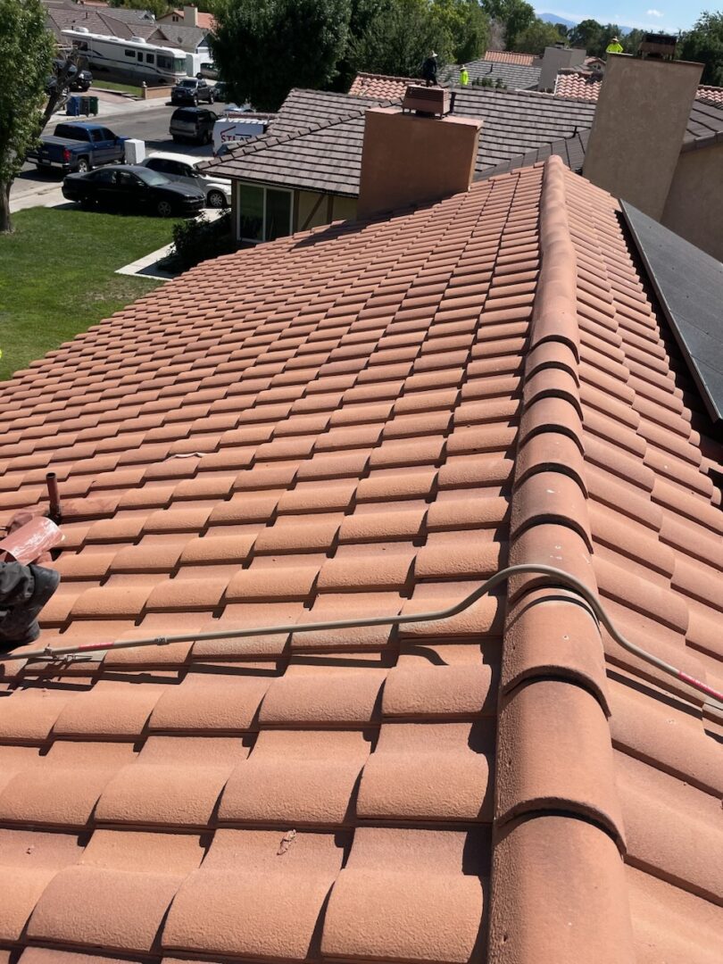 A person is working on the roof of a house.
