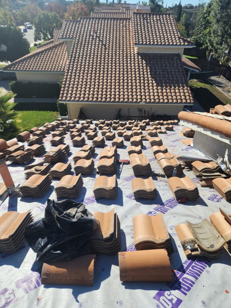 A roof that has many pieces of tile on it.